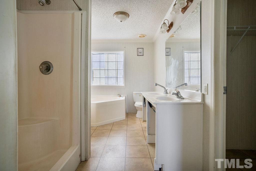 92 Wayland Drive St. Pauls, NC 28384 - Photo 17 of 36 a bathroom with a tub sink and mirror