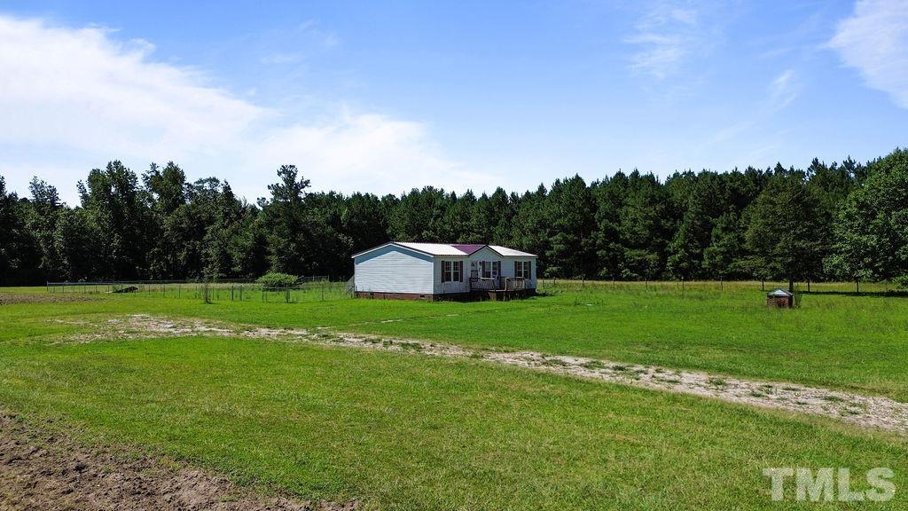 92 Wayland Drive St. Pauls, NC 28384 - Photo 2 of 36 a view of a garden and basketball court