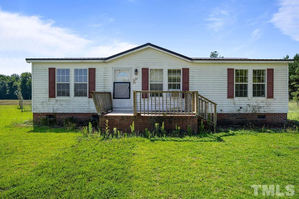 92 Wayland Drive St. Pauls, NC 28384 - Photo 3 of 36 a front view of a house with a yard table and chairs
