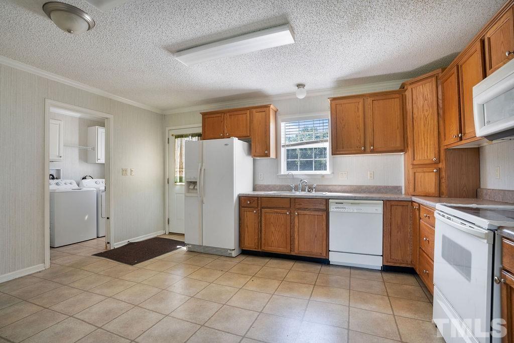 92 Wayland Drive St. Pauls, NC 28384 - Photo 5 of 36 a kitchen with a refrigerator stove and sink