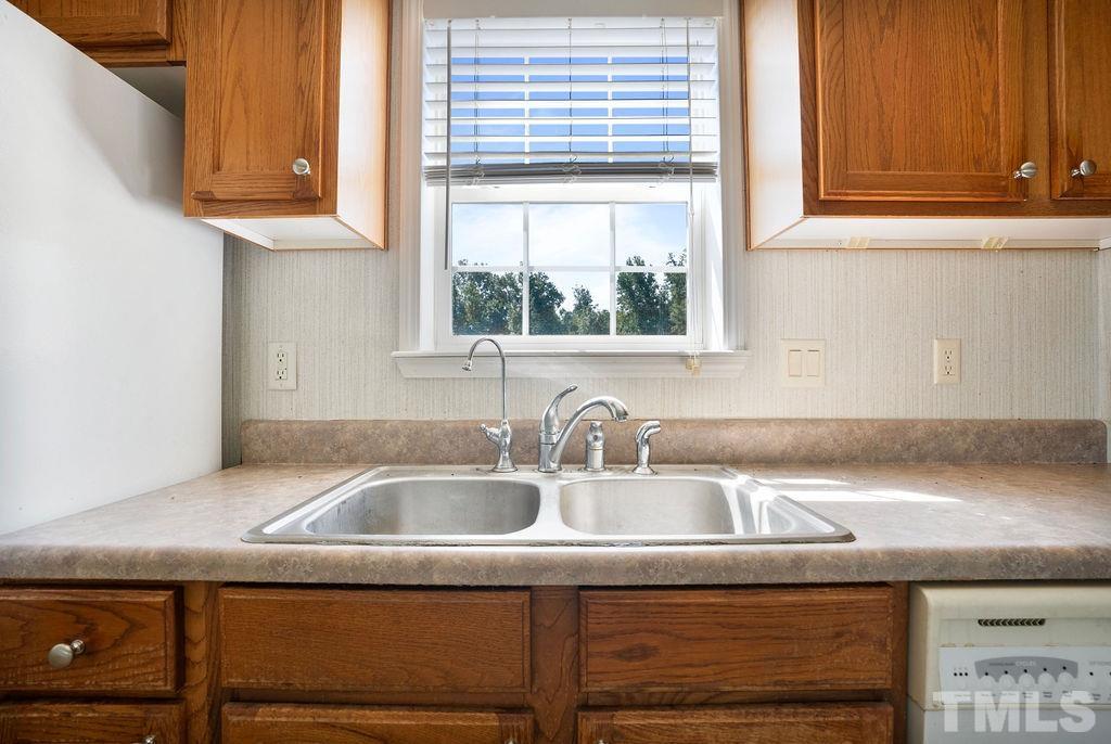 92 Wayland Drive St. Pauls, NC 28384 - Photo 7 of 36 a kitchen with granite countertop a sink and a window