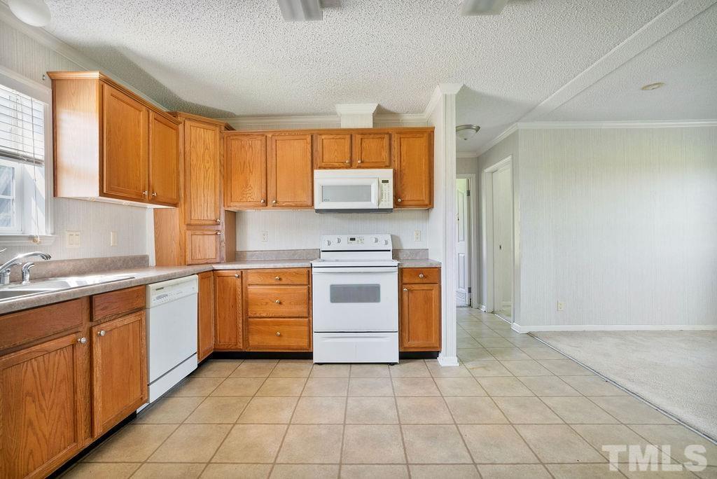 92 Wayland Drive St. Pauls, NC 28384 - Photo 8 of 36 a kitchen with a stove top oven sink and cabinets
