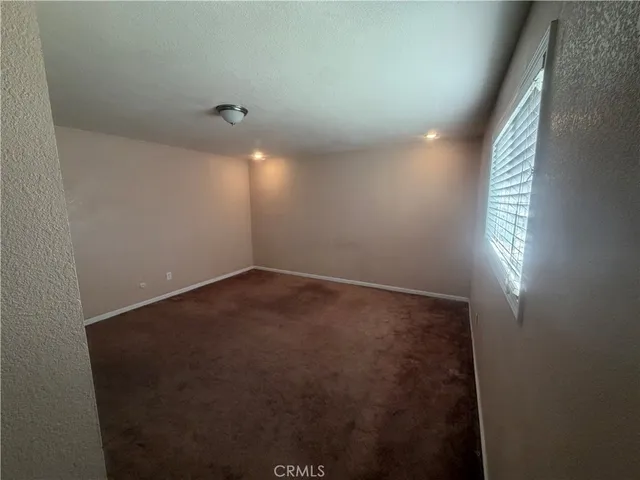 a bathroom with a granite countertop sink a toilet a mirror and shower