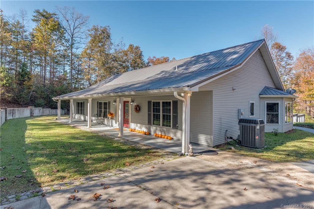 1020 Mountain Creek Road Rutherfordton, NC 28139 - Photo 1 of 48 a front view of a house with a garden and trees