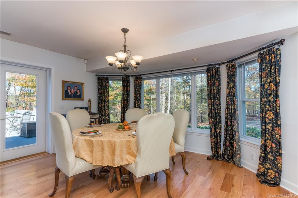 1020 Mountain Creek Road Rutherfordton, NC 28139 - Photo 28 of 48 a dining room with furniture a chandelier and wooden floor