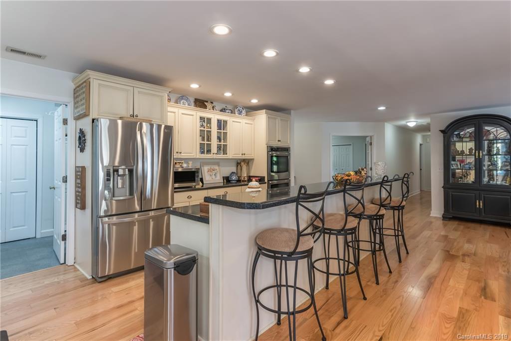 1020 Mountain Creek Road Rutherfordton, NC 28139 - Photo 31 of 48 a kitchen with stainless steel appliances granite countertop a refrigerator and a stove top oven with wooden floor