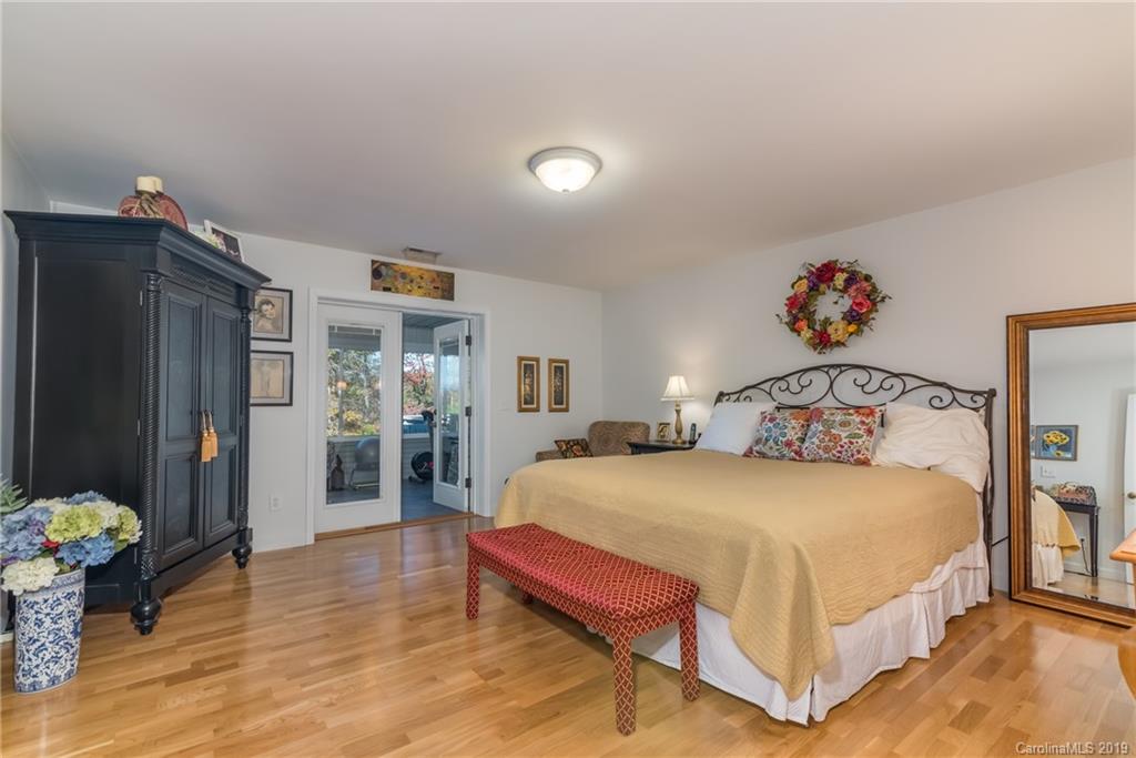 1020 Mountain Creek Road Rutherfordton, NC 28139 - Photo 34 of 48 a bedroom with a bed and a chandelier