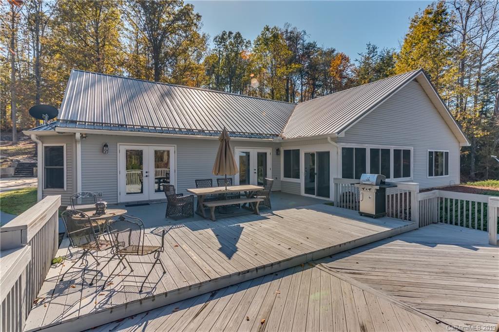 1020 Mountain Creek Road Rutherfordton, NC 28139 - Photo 5 of 48 a view of a house with wooden deck and furniture