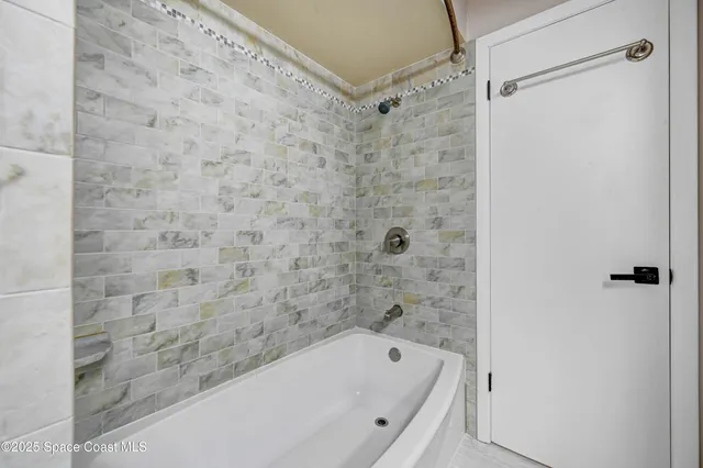 a bathroom with a bathtub and shower