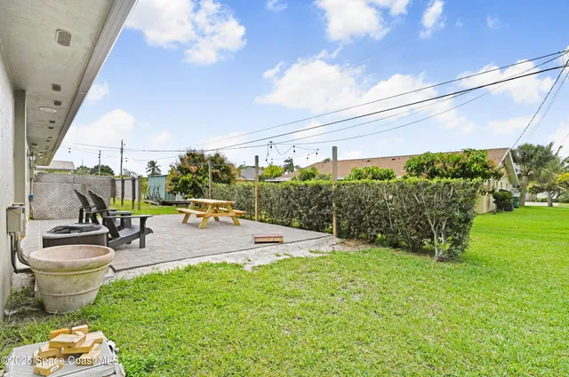 a view of a patio with table and chairs and potted plants
