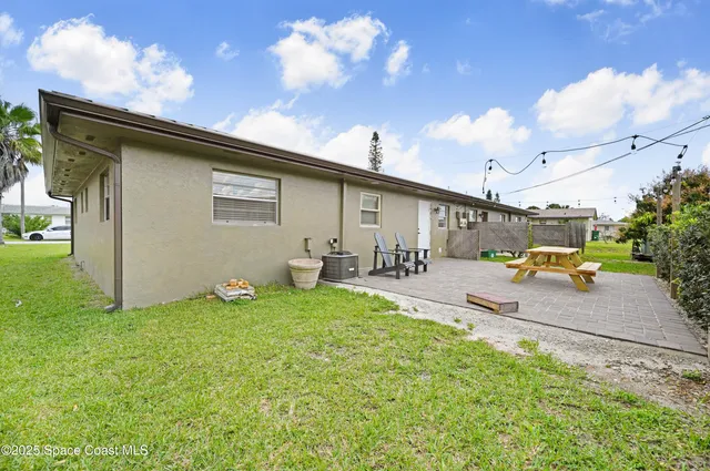 a view of a backyard with sitting area