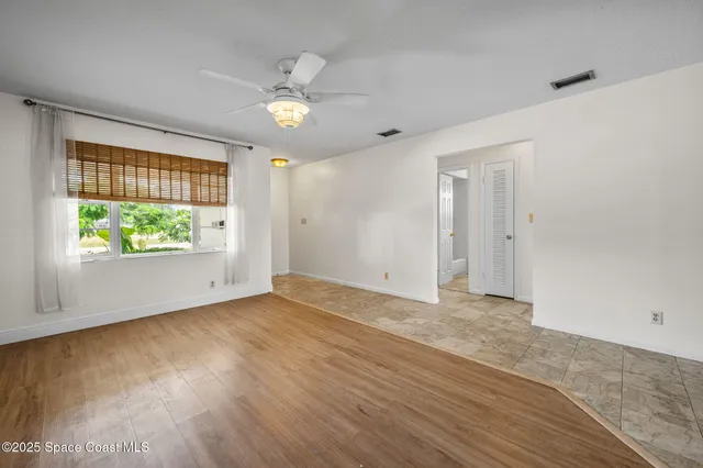a kitchen with white cabinets a sink a stove and a refrigerator