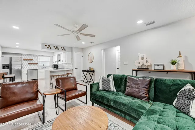 a living room with furniture and kitchen view