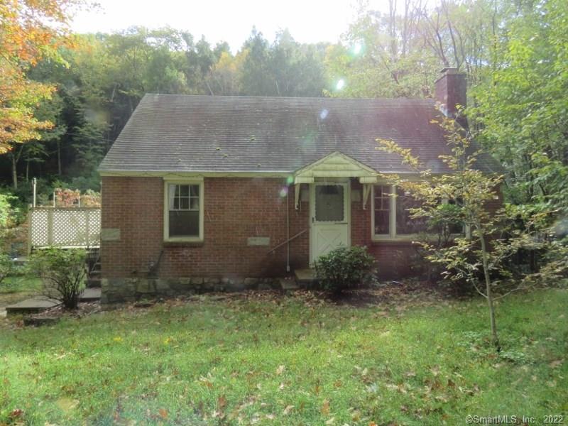 829 Goshen Road Torrington, CT 06790 - Photo 1 of 1 a backyard of a house with plants and large tree