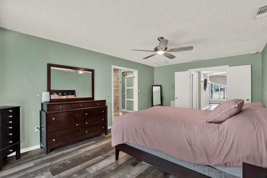 7487 River Country Drive Weeki Wachee, FL 34607 - Photo 26 of 53 a bedroom with a bed and a mirror on dresser