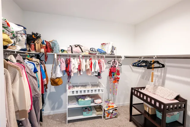 a view of walk in closet with clothes