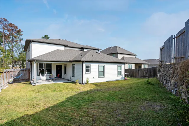 a view of a house with a yard and sitting area