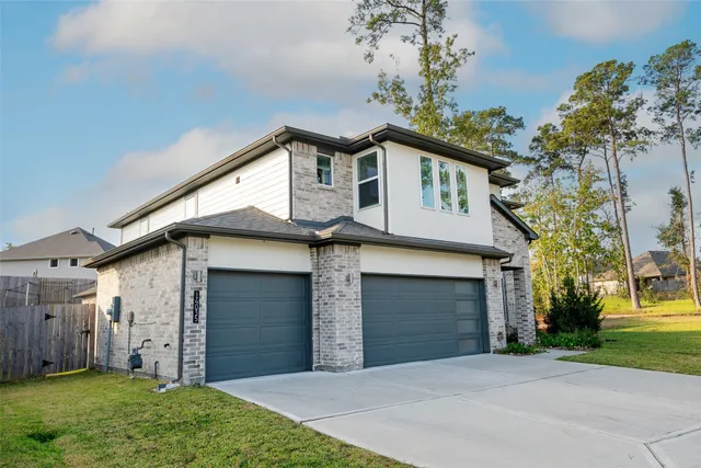 a front view of a house with a garden and yard
