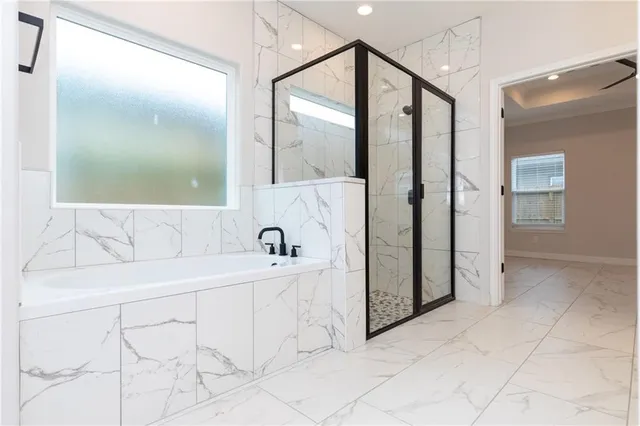 a bathroom with a bathtub and a shower