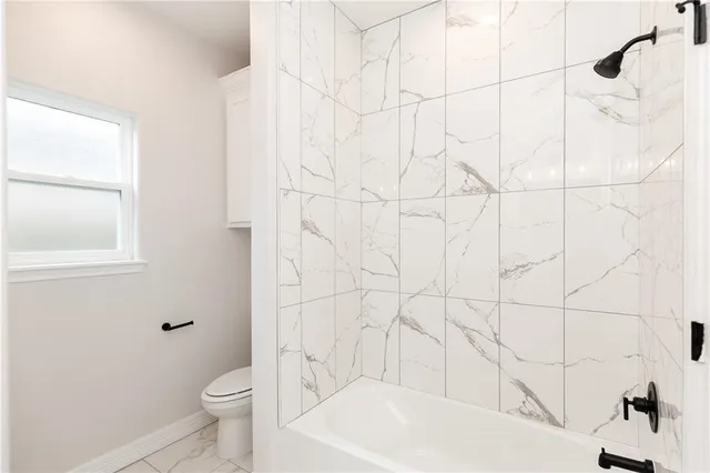 a bathroom with a bathtub and toilet