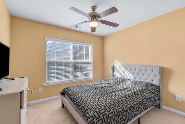 a bedroom with a bed and window