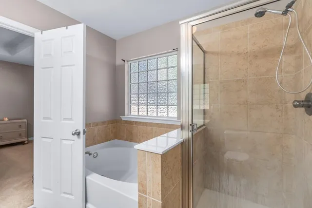a bathroom with a tub and shower