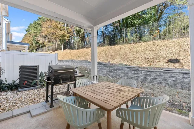 a view of an outdoor sitting area with brick walls