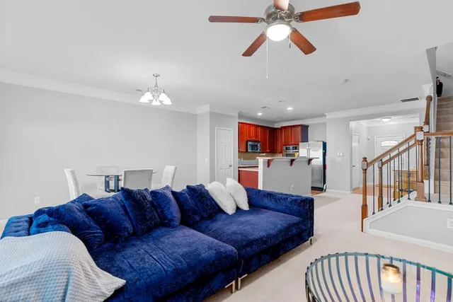 a living room with furniture and a chandelier