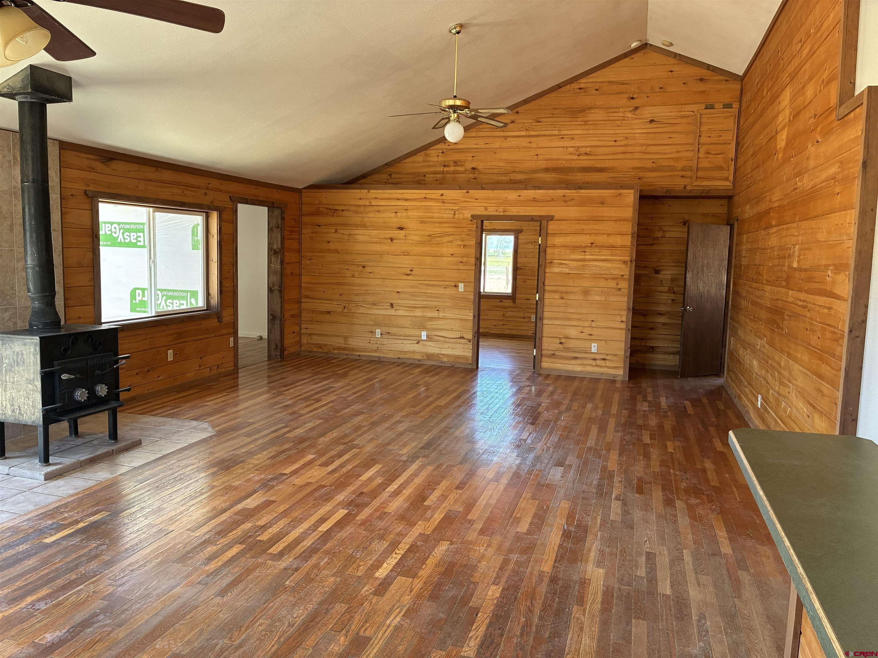 4491 2300th Road Delta, CO 81416 - Photo 2 of 25 a view of an empty room with wooden floor and a window