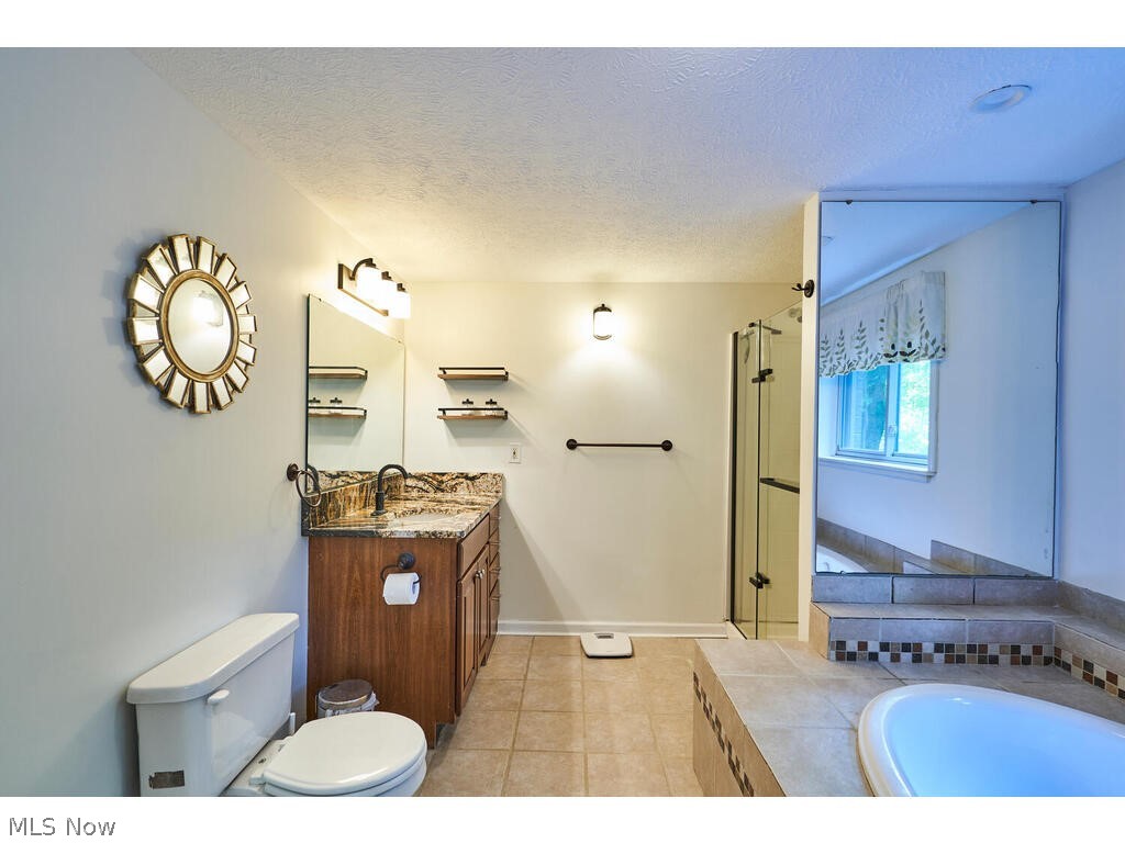 1123 South Hametown Road Akron, OH 44321 - Photo 14 of 37 The Master Bath has been updated with a jetted tub, separate shower, updated vanity with granite top and tiled floor.