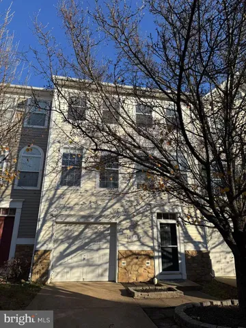 a front view of a house with trees