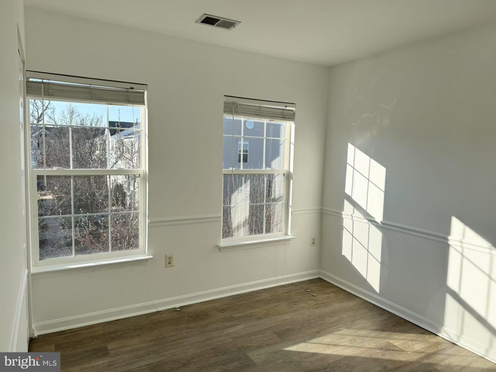 21764 Goose Cross Terrace Ashburn, VA 20147 - Photo 14 of 21 an empty room with wooden floor and windows