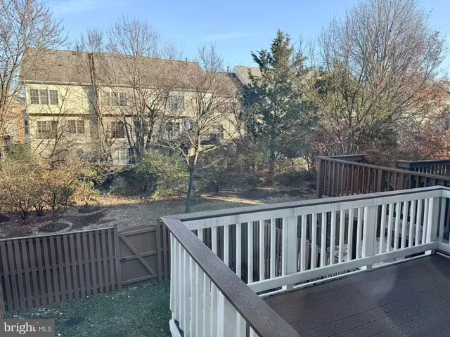 a view of a roof deck with wooden fence and floor