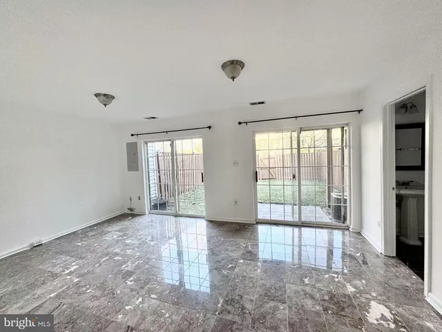a view of an empty room with glass door
