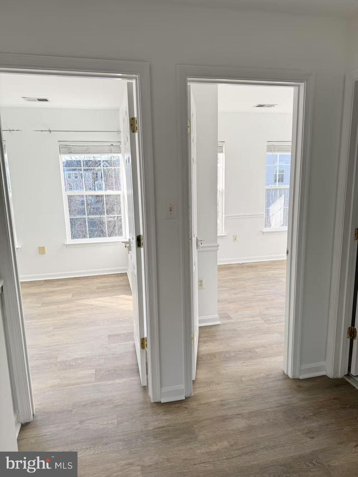 21764 Goose Cross Terrace Ashburn, VA 20147 - Photo 9 of 21 a view of an empty room with wooden floor and a window