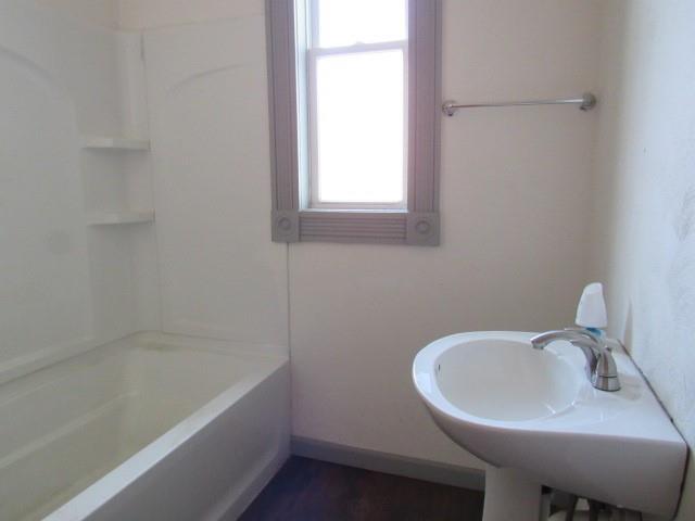 25 Ben Lomond Street Uniontown, PA 15401 - Photo 17 of 24 a bathroom with a sink a bathtub and a window