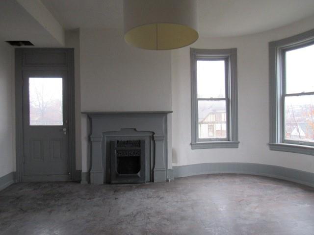 25 Ben Lomond Street Uniontown, PA 15401 - Photo 8 of 24 an empty room with windows and fireplace