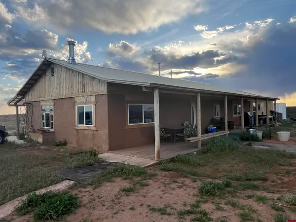 a front view of a house with sitting space