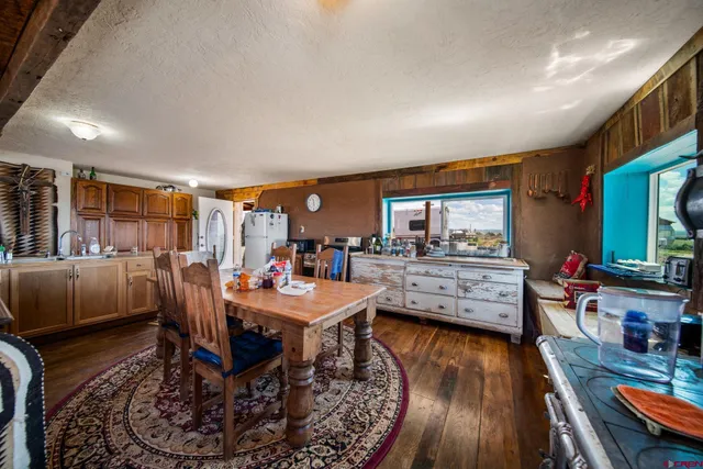 a dining room with furniture and wooden floor
