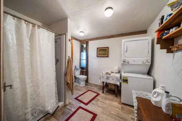 a living room with furniture a rug and a window