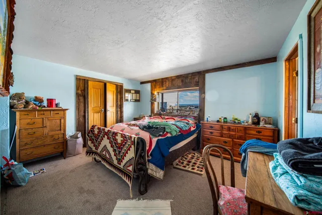 a bed room with a bed and a window