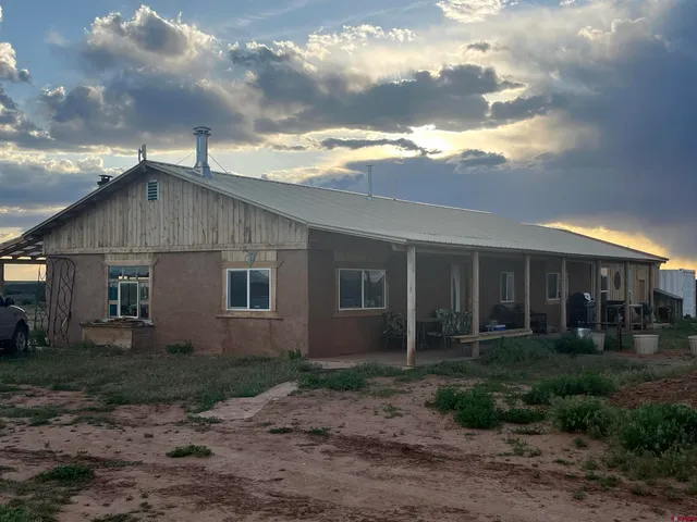 a view of house with yard and green space
