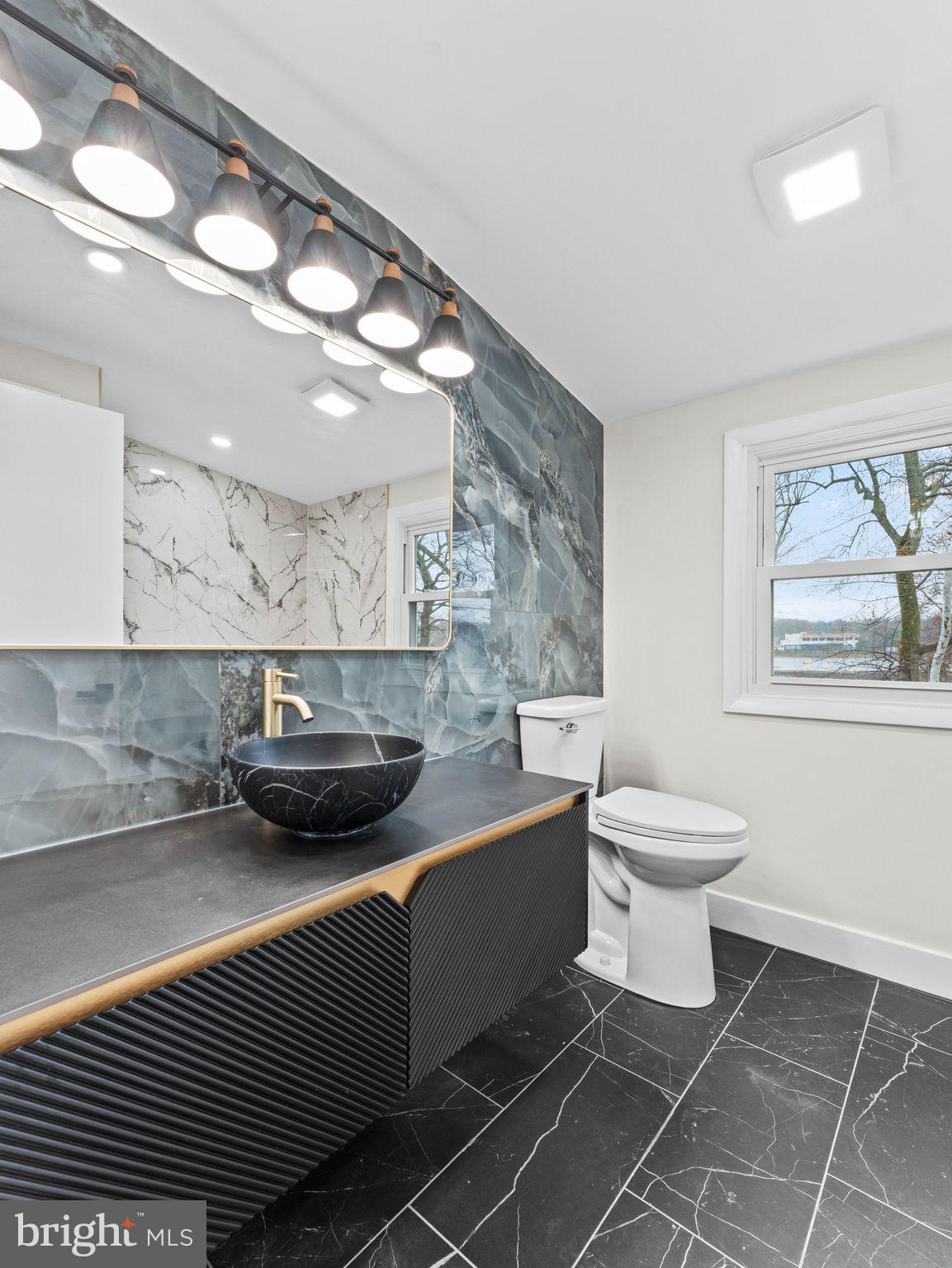 50 Tweedstone Lane Willingboro, NJ 08046 - Photo 34 of 45 a bathroom with a toilet a sink and mirror