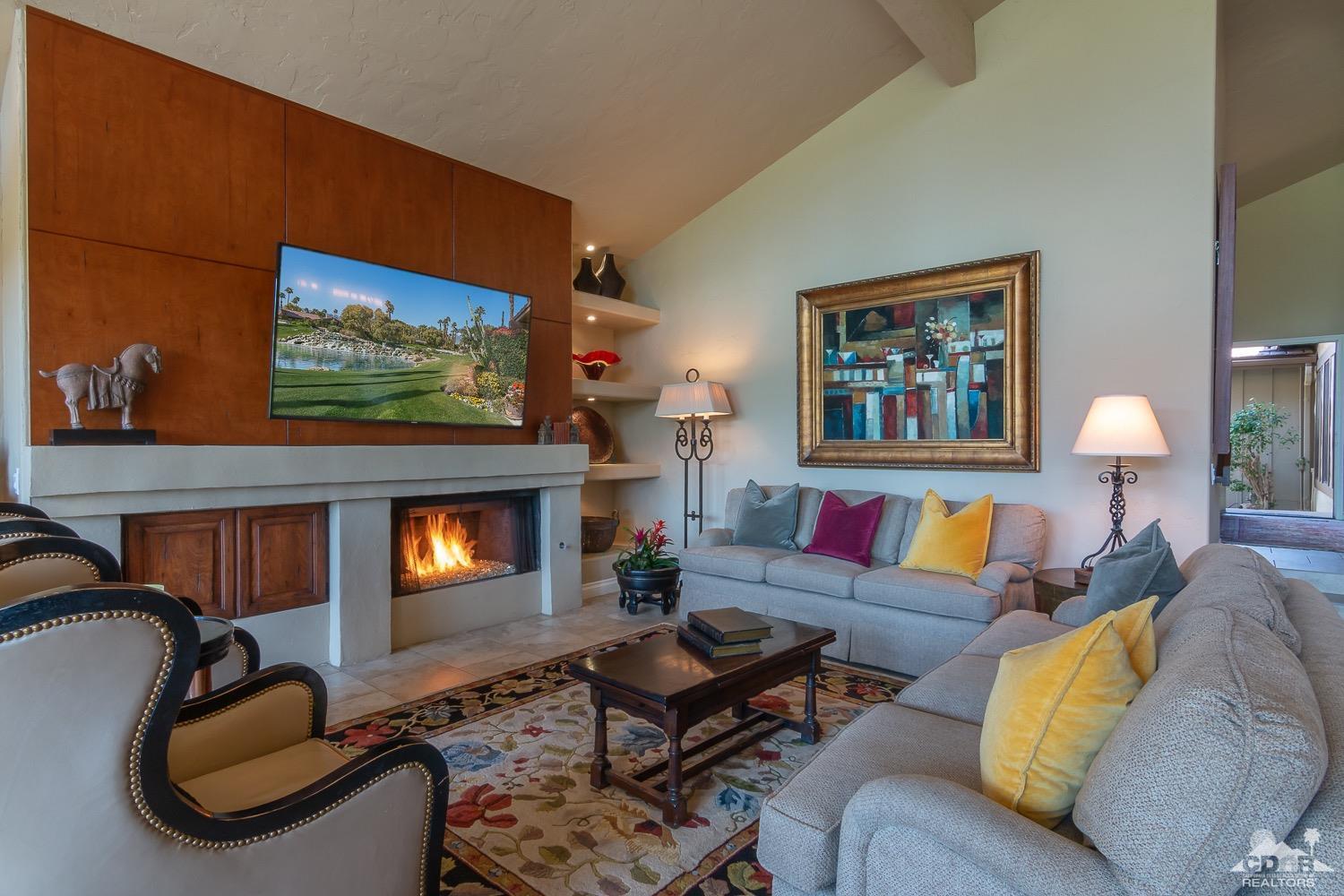 353 Red River Road Palm Desert, CA 92211 - Photo 11 of 28 a living room with furniture a flat screen tv and a fireplace