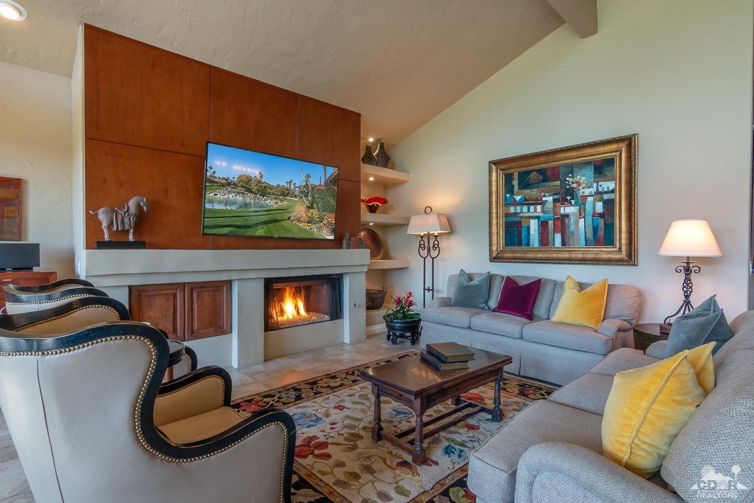 353 Red River Road Palm Desert, CA 92211 - Photo 12 of 28 a living room with furniture a fireplace and wall paintings