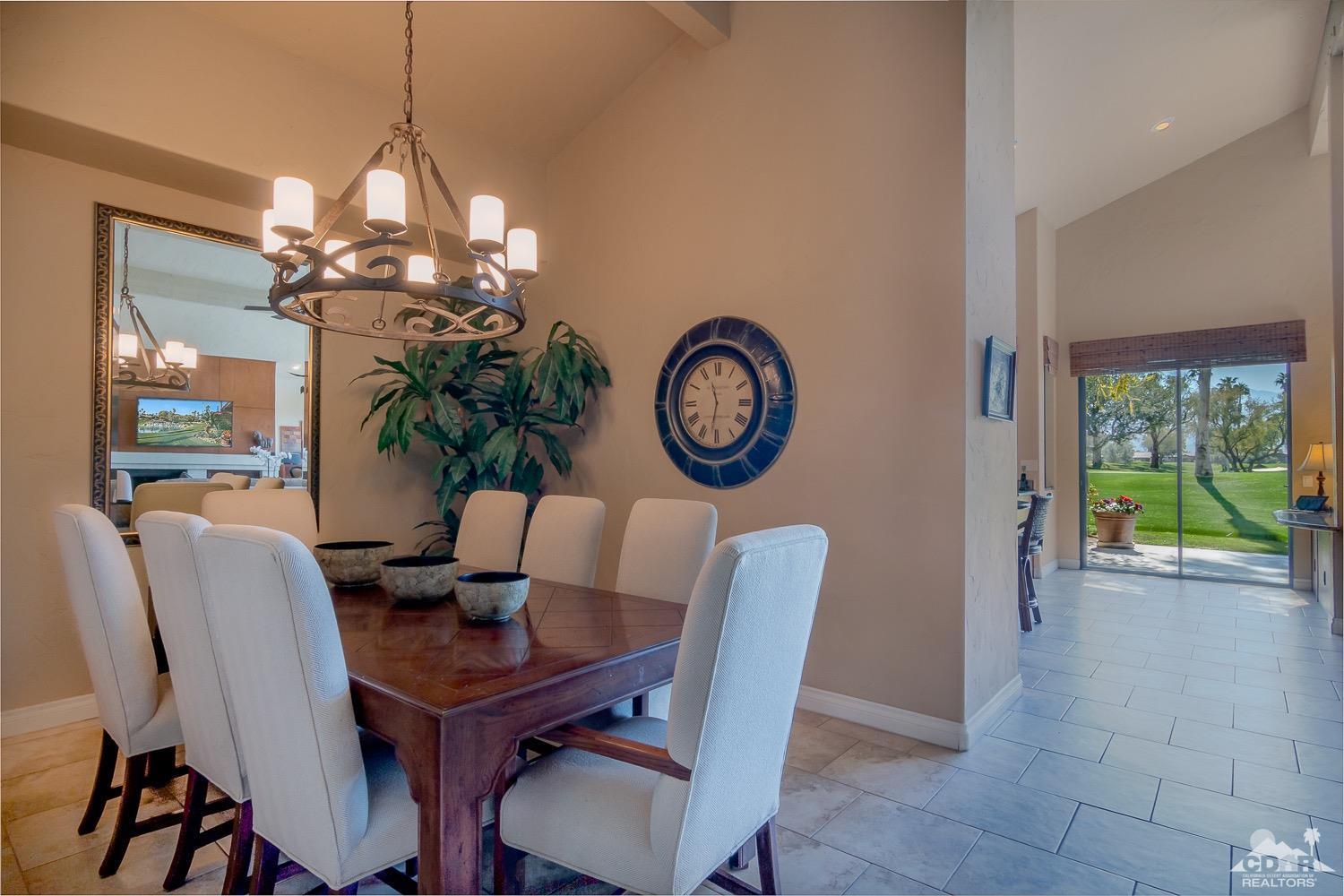 353 Red River Road Palm Desert, CA 92211 - Photo 14 of 28 a view of a dining room with furniture a chandelier and wooden floor