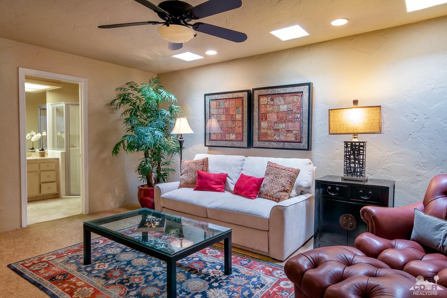 353 Red River Road Palm Desert, CA 92211 - Photo 17 of 28 a living room with furniture and a potted plant