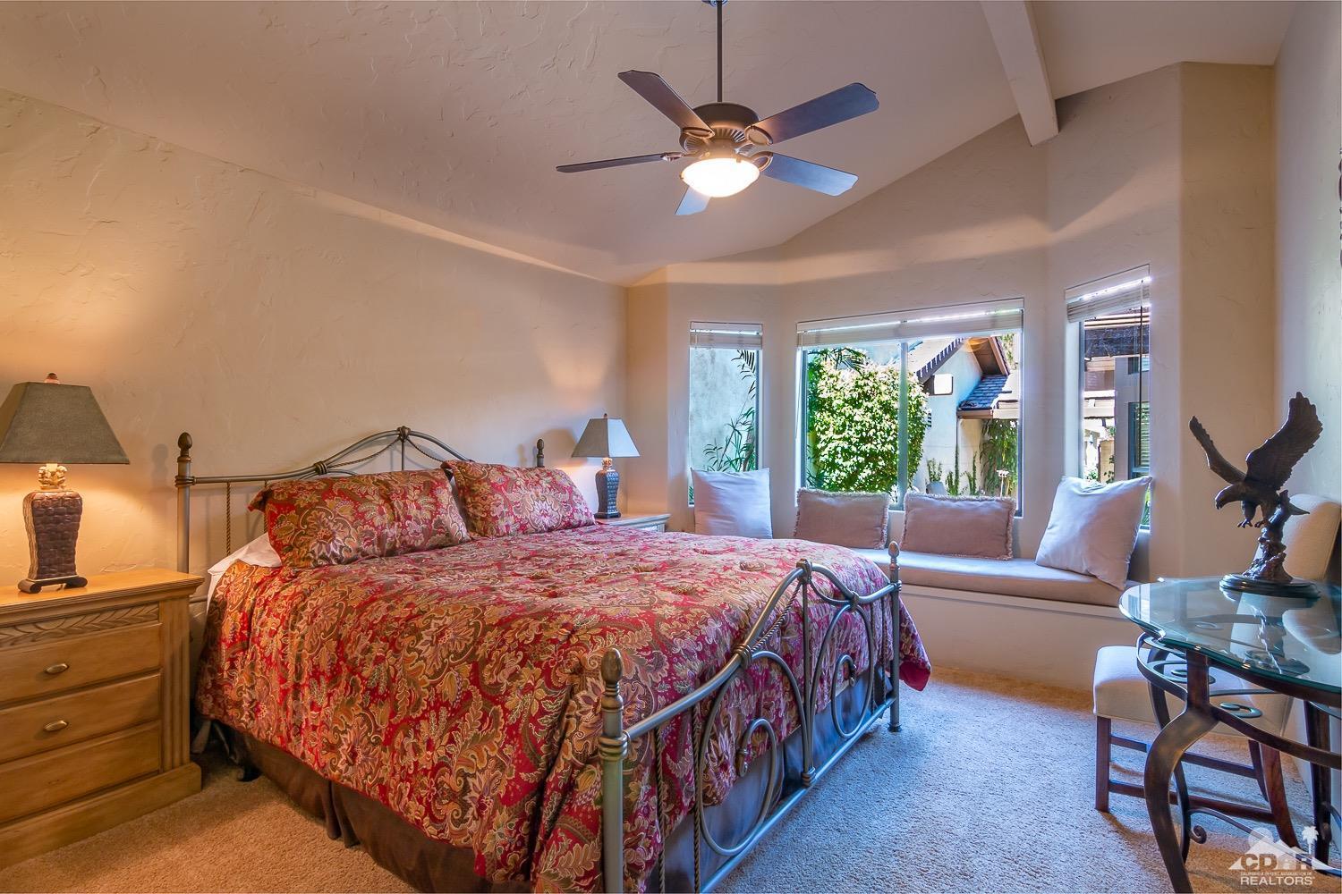 353 Red River Road Palm Desert, CA 92211 - Photo 19 of 28 a bedroom with a bed and a chandelier