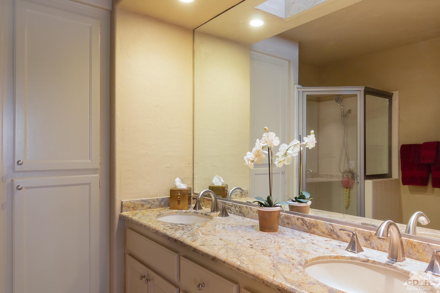 353 Red River Road Palm Desert, CA 92211 - Photo 20 of 28 a bathroom with a granite countertop sink and a mirror