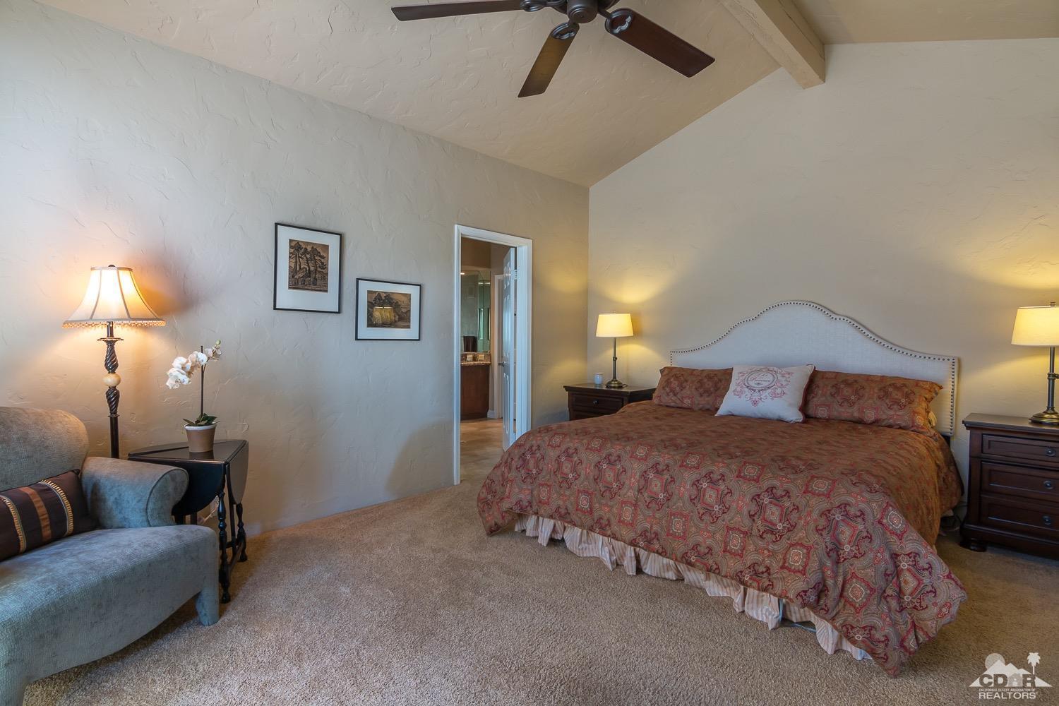 353 Red River Road Palm Desert, CA 92211 - Photo 21 of 28 a bedroom with a bed and a couch